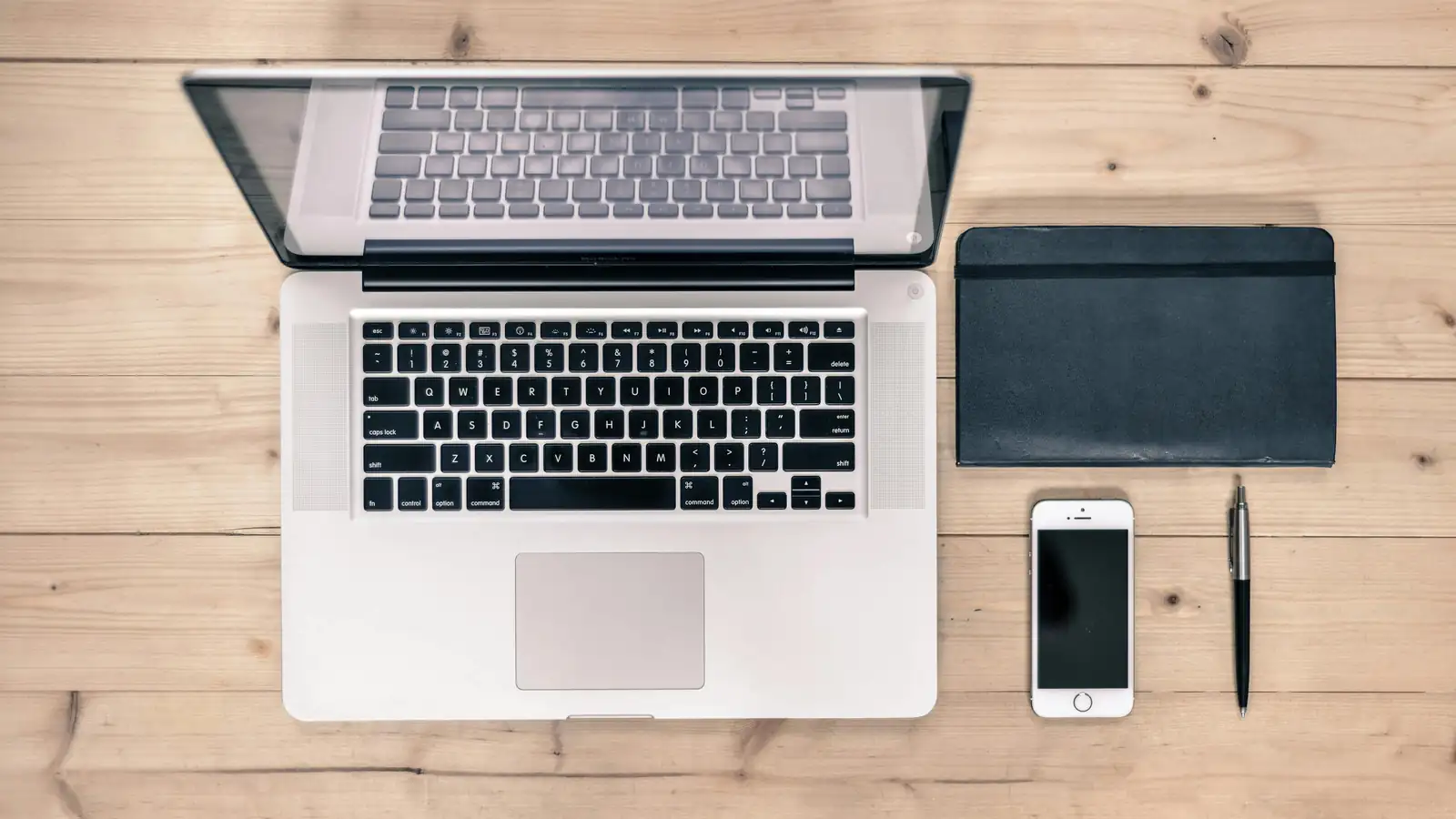 Desk with devices showing world map for online support