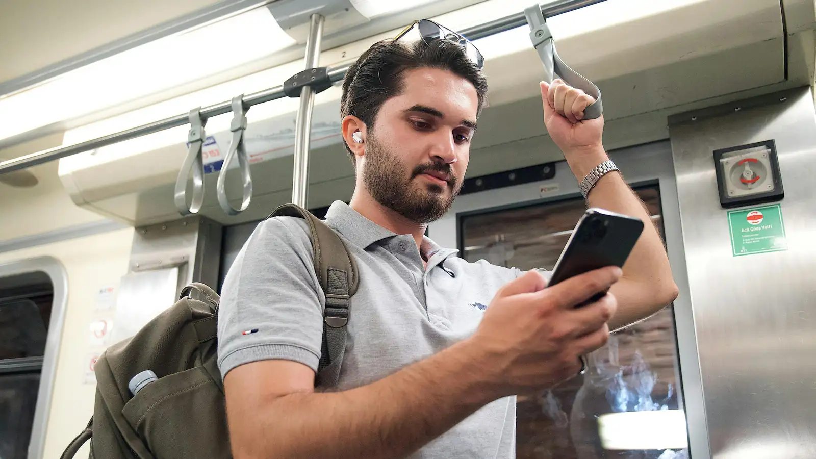 Smiling commuter learning languages on smartphone