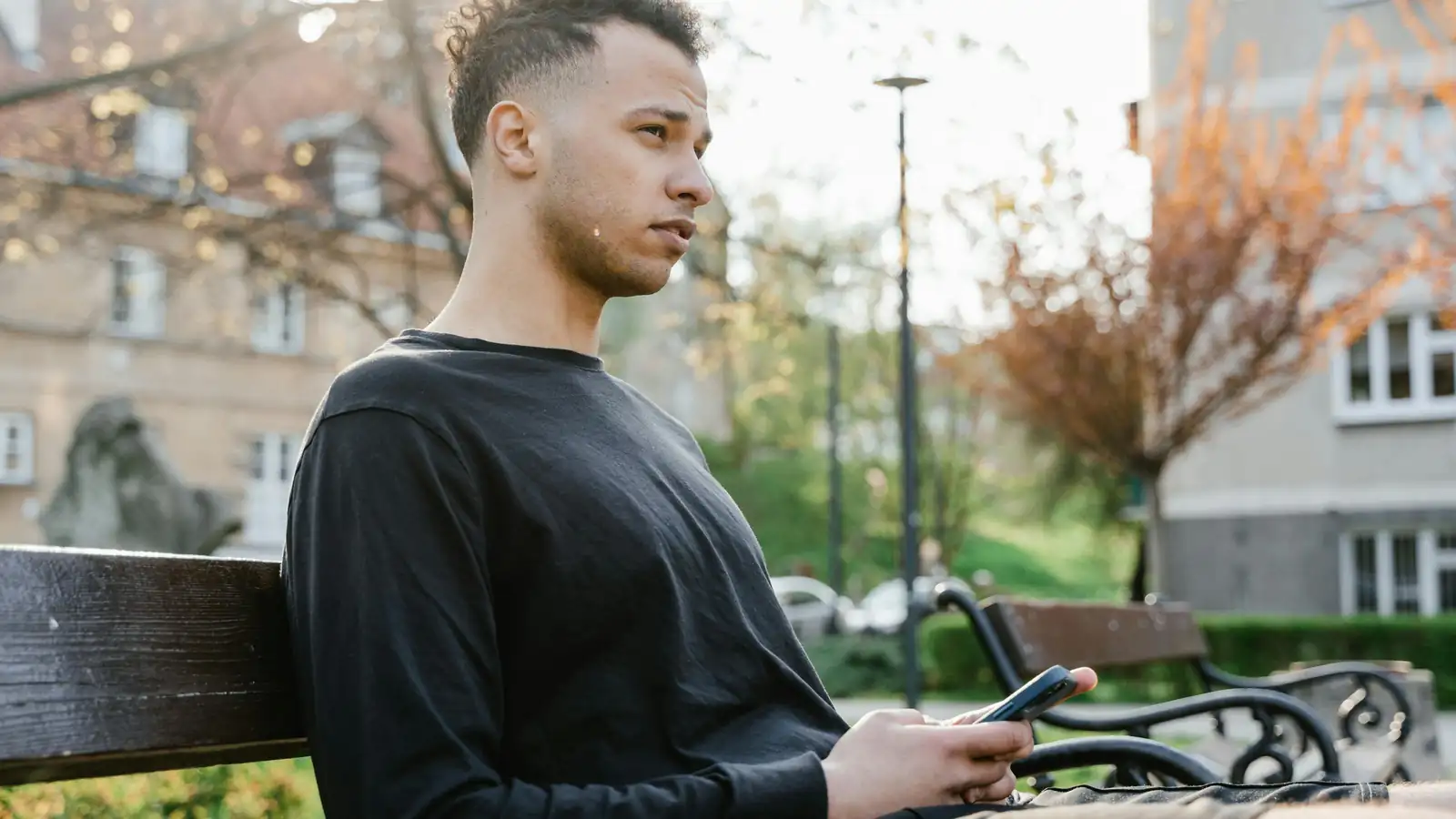 Learner reviewing vocabulary on phone outdoors