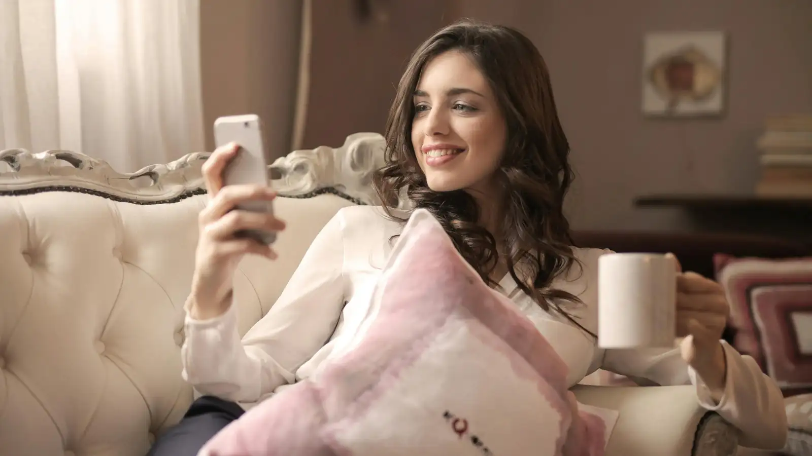 Young woman learning a language on her phone at home