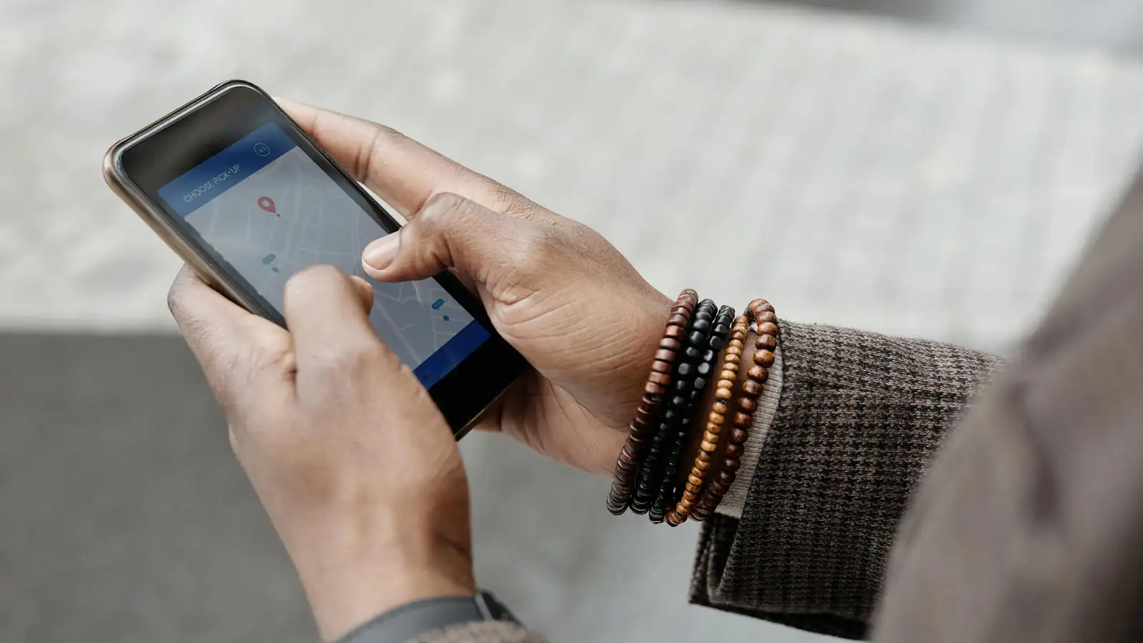Hands holding phone with city map on screen
